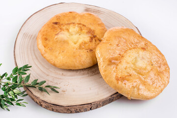 Delicious Georgian khachapuri - closed baked pie with homemade cheese isolated on white background