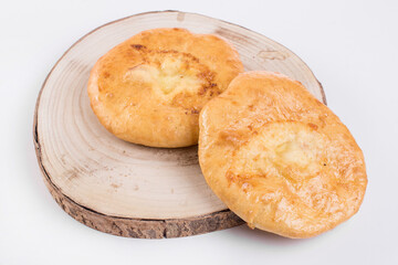 Delicious Georgian khachapuri - closed baked pie with homemade cheese isolated on white background