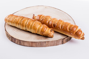 Baking a fresh bun filled with meat isolated on white background