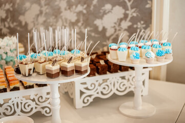 Sweet cakes in cups at a wedding buffet. Candy bar catering