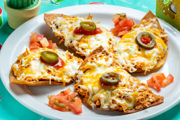 Appetizing mexican chicken tacos with melted cheese.
