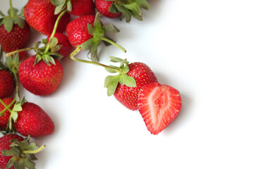 Healthy red fresh strawberry isolated on white background. Strawberry slice in the foreground. Copy space. Top view. Strawberries background. Food background.
