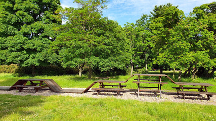 Wooden structure of tables and benches in the park