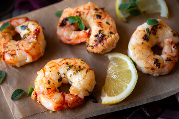 Roasted shrimps with lemon and herbs, healthy seafood meal
