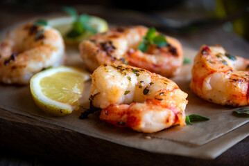 Roasted shrimps with lemon and herbs, healthy seafood meal