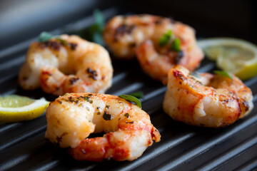 Roasted shrimps with lemon and herbs, healthy seafood meal