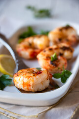 Roasted shrimps with lemon and herbs, healthy seafood meal