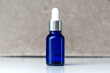 bottle with blue cosmetic skin serum. bottle with a pipette for female cosmetics