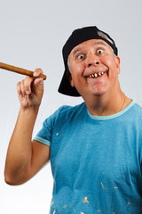 Funny looking man with bad teeth holding a cigar