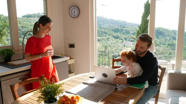 Father and son using laptop at home