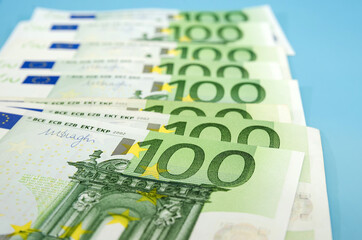 100 euro banknotes on a blue background. Financial concept. Money background