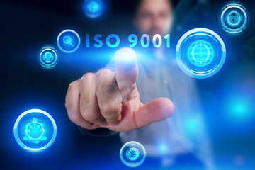 Business, Technology, Internet and network concept. Young businessman working on a virtual screen of the future and sees the inscription: ISO 9001
