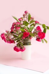 bouquet of small roses in a vase on an empty background