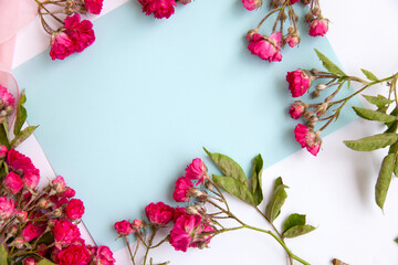 bright composition frame with roses. Space for text is empty.