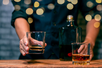 Barman pouring whiskey whiskey glass