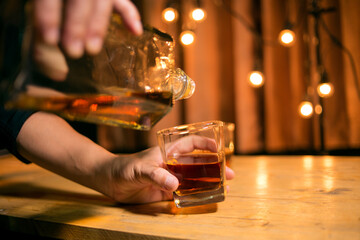 Barman pouring whiskey whiskey glass