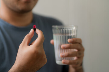 Close up handsome  man taking pill. Medicine, health  care concept.