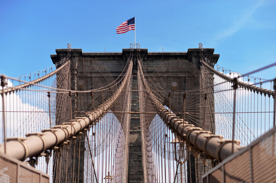 Brooklyn bridge with united states flag on top