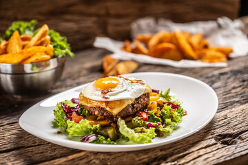Vegetarian bean patty salad with melted cheese and sunny side up egg