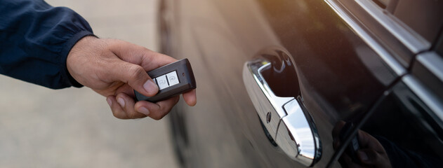 Close up car keys and remote control car alarm systems hold in hand