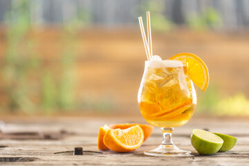 Beer lemonade with orange and ice on a garden table during a hot summer day