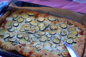 Homemade gallete with cheese and zucchini, served on a picnic galette. Selective focus.