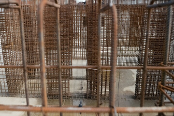 Detail with reinforcing iron bars on a construction site/ Rebar iron bars. Construction worker in the background.