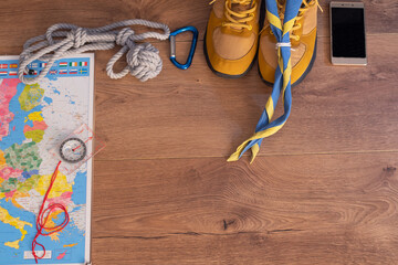 travel and adventure items in a wooden background. Space for text