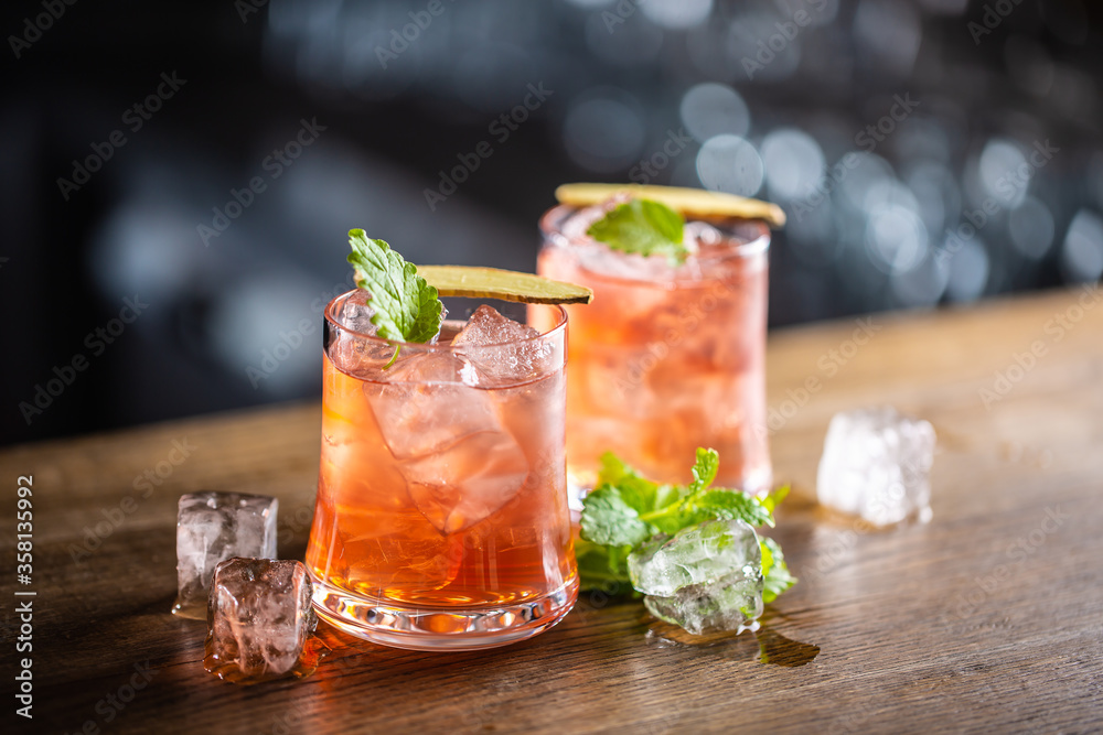 Wall mural sea breeze cocktail with ice and fresh mint, on a dark background