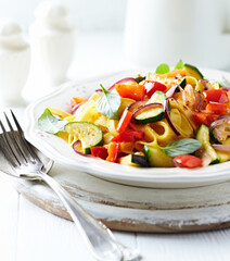 Pappardelle Pasta with Vegetables and fresh Basil on bright wooden Backgrounbd. 