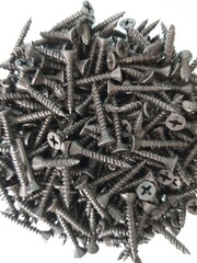 Black metal screws in a jar