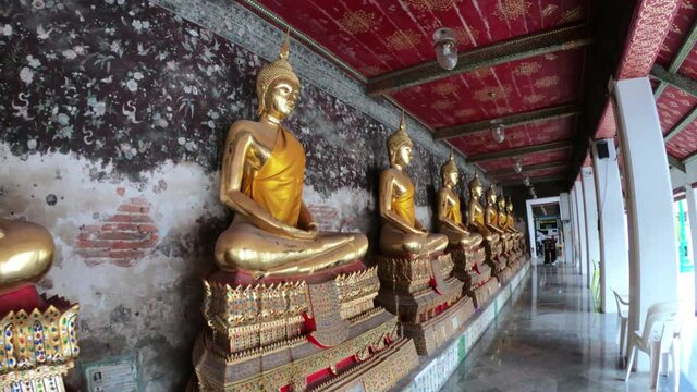 Golden Meditating Buddha Statues Sitting In A Row In A Corridor In Wat Suthat Thepwararam Temple Bankok, Thailand 25/11/2019