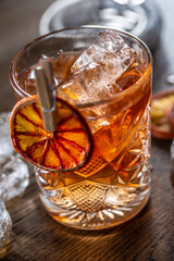 Smoked old fashioned cocktail with ice in an ornamental glass
