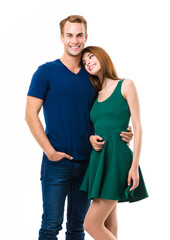Smiling young amorous couple. Portrait picture of embracing models at happy in love studio concept, isolated over white background. Man and woman in casual clothing posing together.