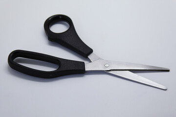 Scissors - a cutting tool, formed by two steel blades articulated and joined on an axis, used to cut materials such as fabric, paper and others