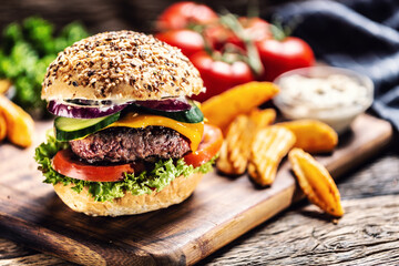 Beef burger with cucumber and onion in a sesame bun