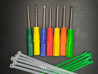 A set of multi-colored screwdrivers and mounting brackets