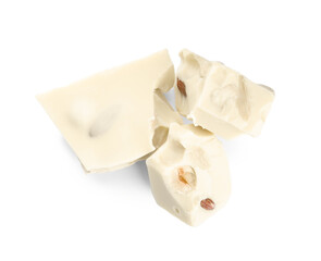 Pieces of delicious chocolate with nuts isolated on white, top view