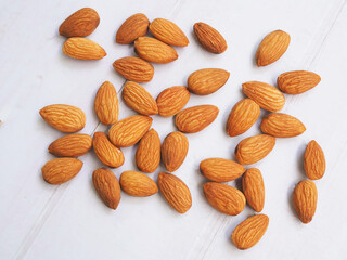 Almond seeds isolated on white table.