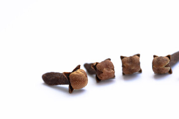 dry clove grains on white background