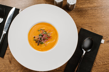 Healthy lentils cream soup on wooden background