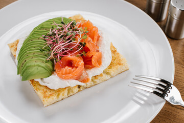 Tasty vegetarian sandwich with avocado and red fish