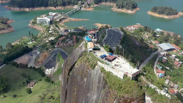 Peñón de Guatapé in Colombia is natural wonder a giant stone which was created by clash of tectonic plates. Drone orbiting view of famous Piedra del Peñol. 