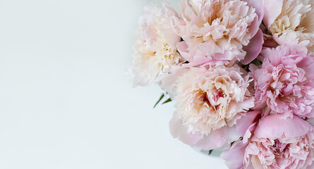 Decorative still life, flower arrangement. Wedding or holiday bouquet of delicate pink peony flowers. shabby white table background. Flat lay, top view. Summer concept. selective focus. Banner