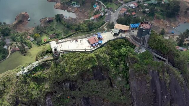 Amazing aerial drone video of Guatapé in Colombia. Revealing shot of Guatapé over the famous Piedra del Peñol. Colombian natural wonders.