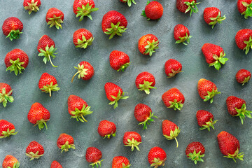 Fresh strawberry pattern on a gray background. Top view, flat lay. Beautiful creative berry texture.