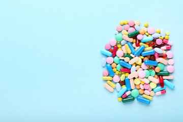 Colorful pills on blue background