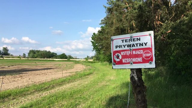 Private property entry forbidden sign next to a country farm path road on a sunny summer day in poland