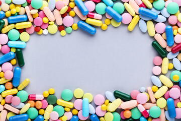 Fototapeta na wymiar Colorful pills on grey background