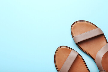 Female beige sandals on mint background